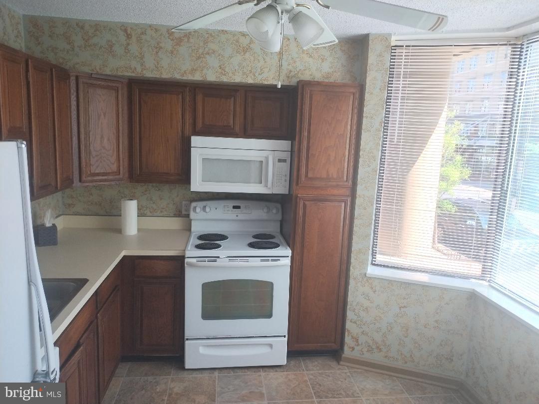 2141 P Street Northwest, Unit 202 Washington, DC 20037 - Photo 8 of 30 a kitchen with a stove and a microwave