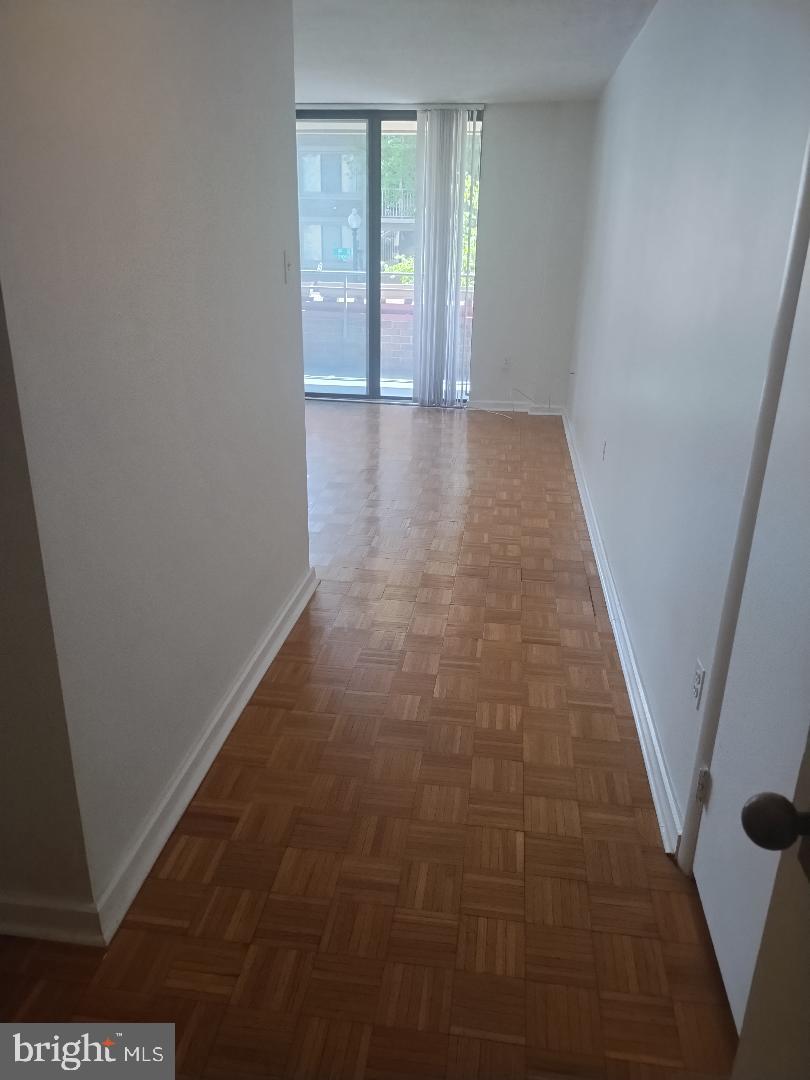 2141 P Street Northwest, Unit 202 Washington, DC 20037 - Photo 10 of 30 wooden floor in an empty room with a window