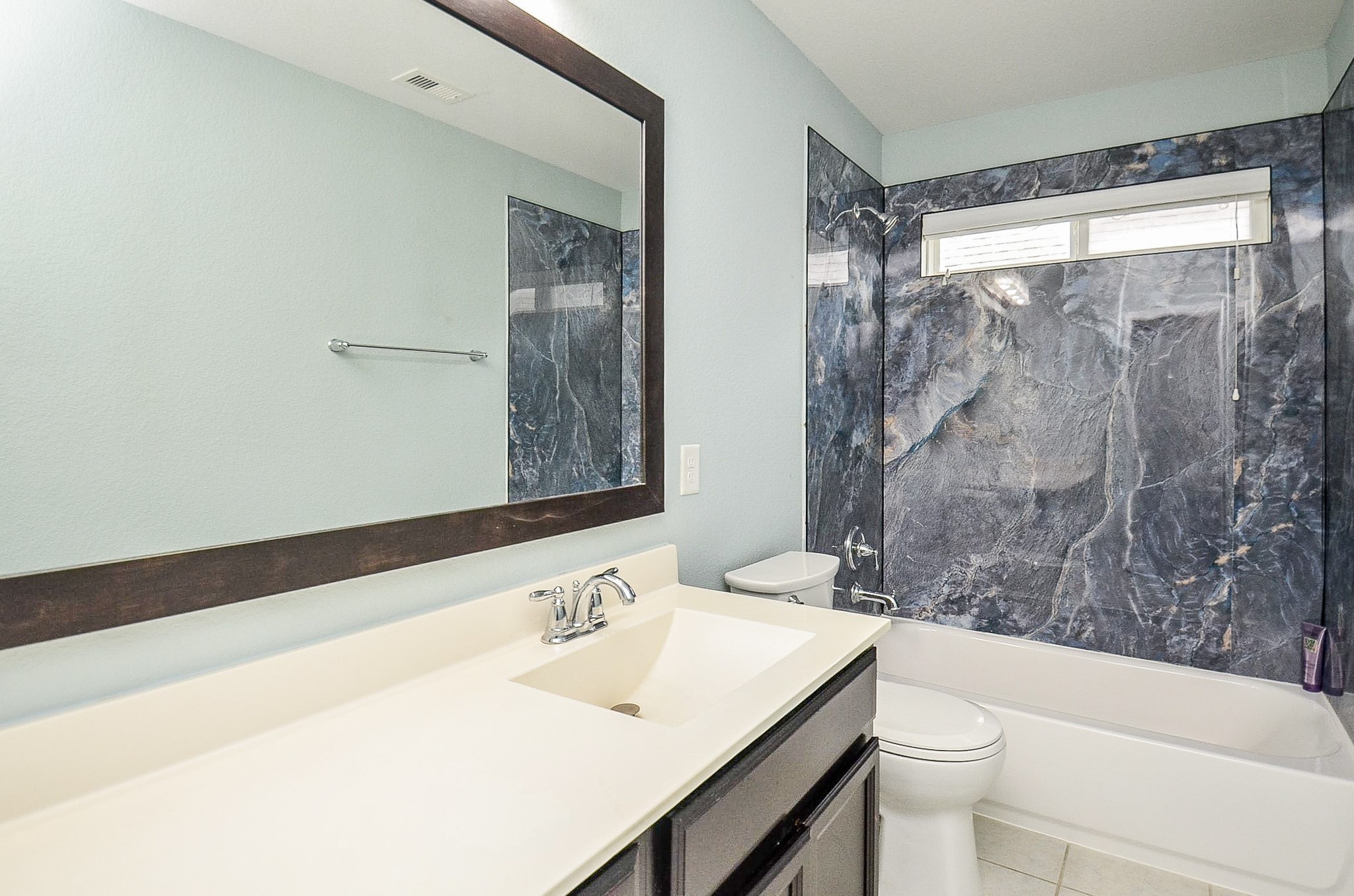 7042 Sliding Rock Circle Spring, TX 77379 - Photo 20 of 36 Elegant third bathroom featuring a sleek vanity, luxurious marble-style shower, and ample natural light. Ideal for guests or family.