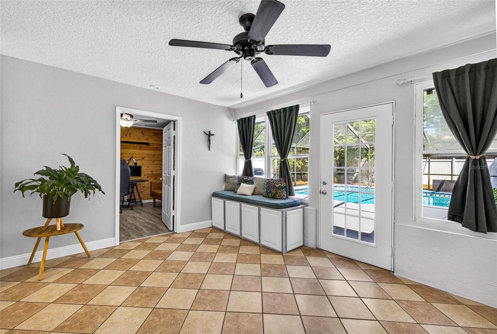 9043 Mc Cormick Street Spring Hill, FL 34608 - Photo 23 of 47 a living room with a couch and a dining table