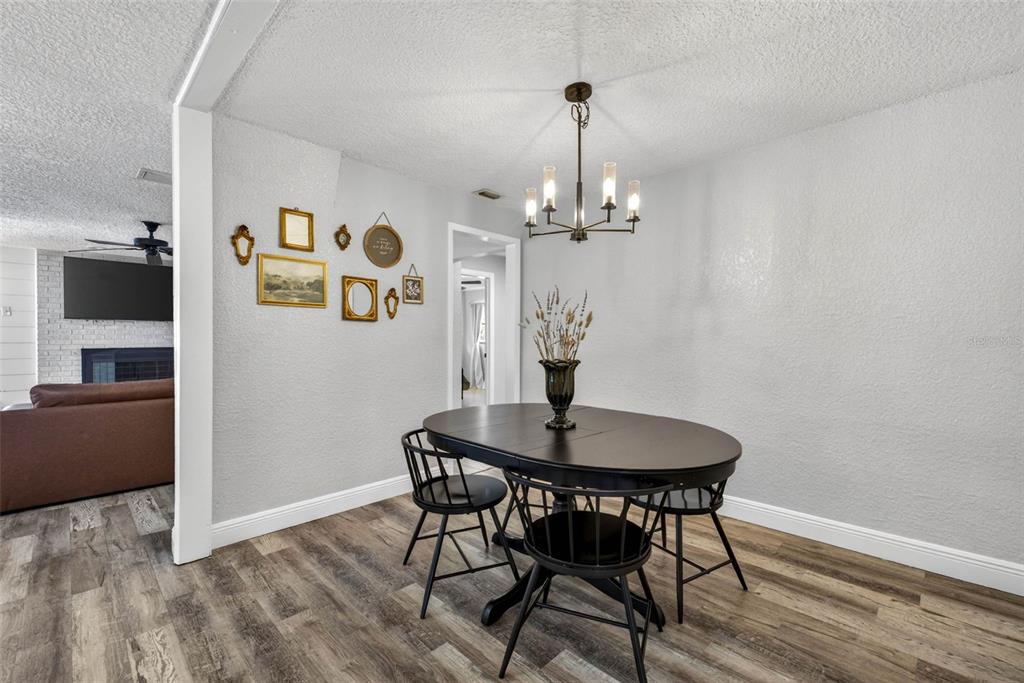 9043 Mc Cormick Street Spring Hill, FL 34608 - Photo 25 of 47 a view of a dining room with furniture and wooden floor
