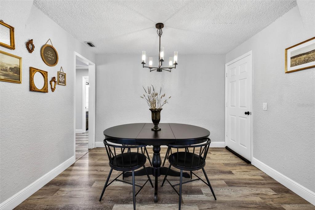 9043 Mc Cormick Street Spring Hill, FL 34608 - Photo 26 of 47 a dining room with table and chairs