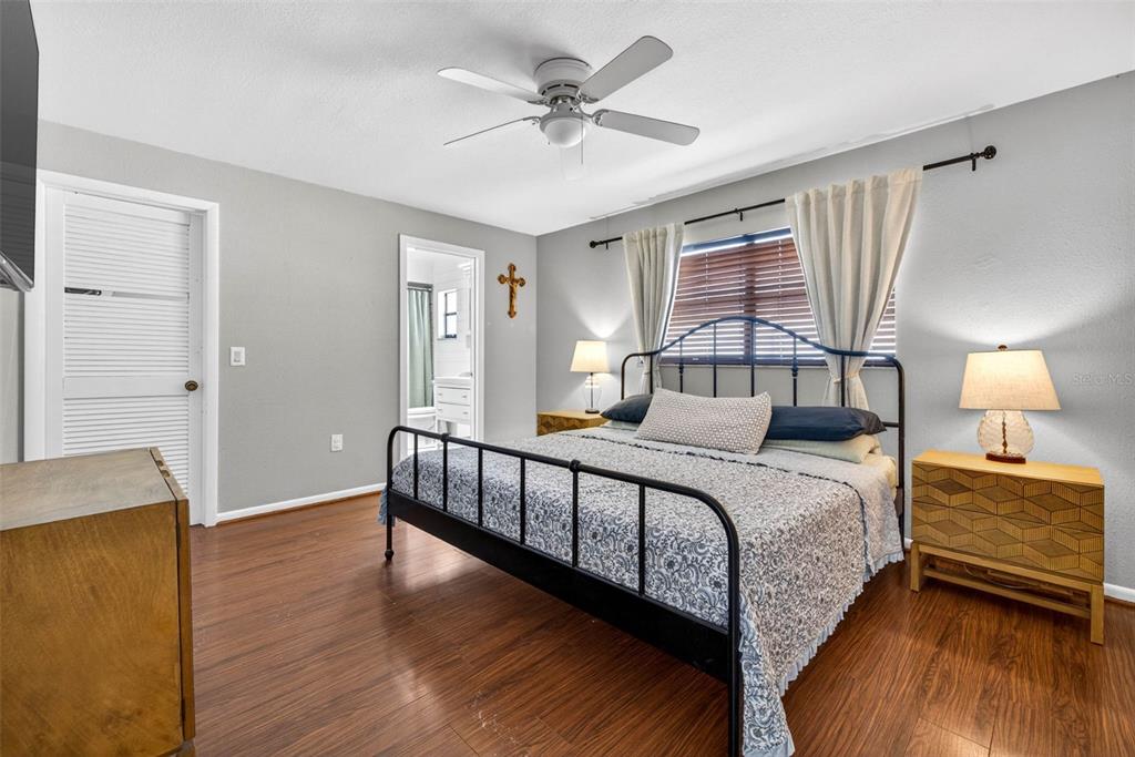 9043 Mc Cormick Street Spring Hill, FL 34608 - Photo 36 of 47 a bedroom with a bed and a chandelier