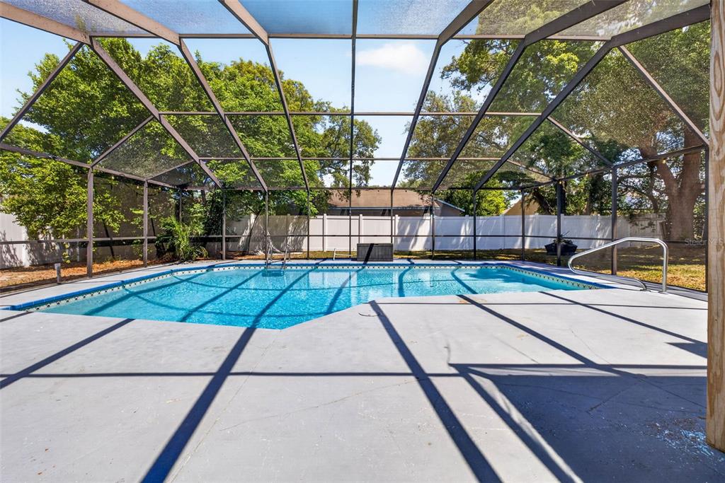 9043 Mc Cormick Street Spring Hill, FL 34608 - Photo 42 of 47 a view of backyard with a small swimming pool