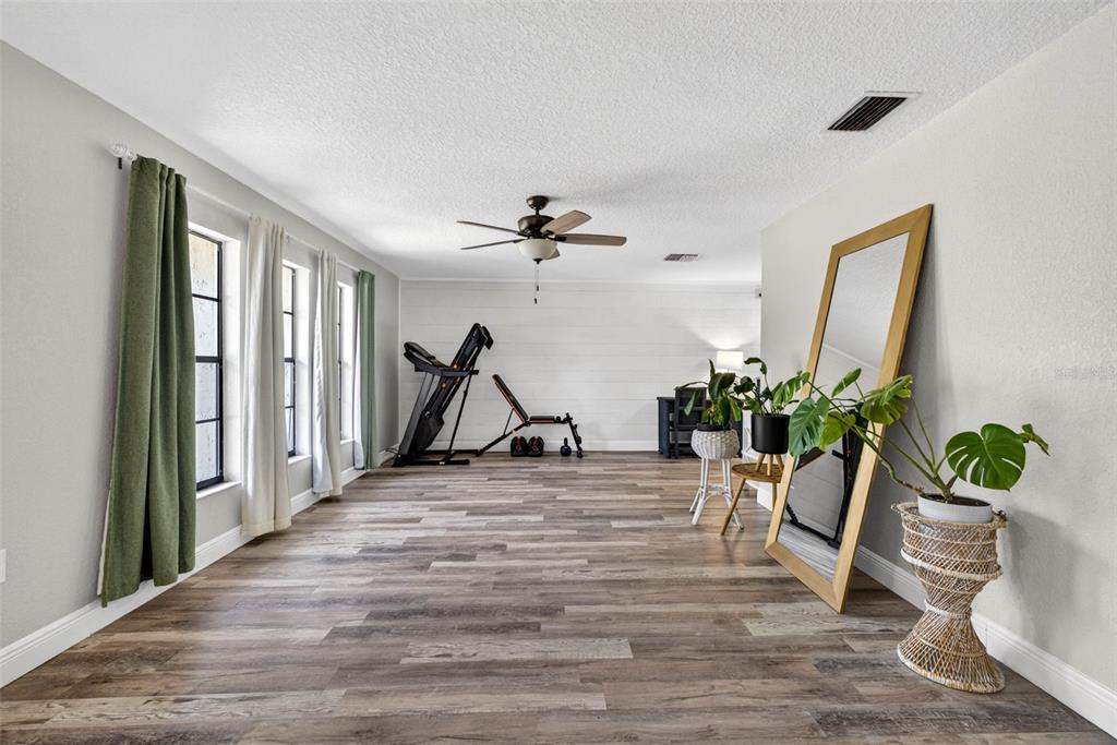 9043 Mc Cormick Street Spring Hill, FL 34608 - Photo 9 of 47 a view of a workspace with furniture and a potted plant