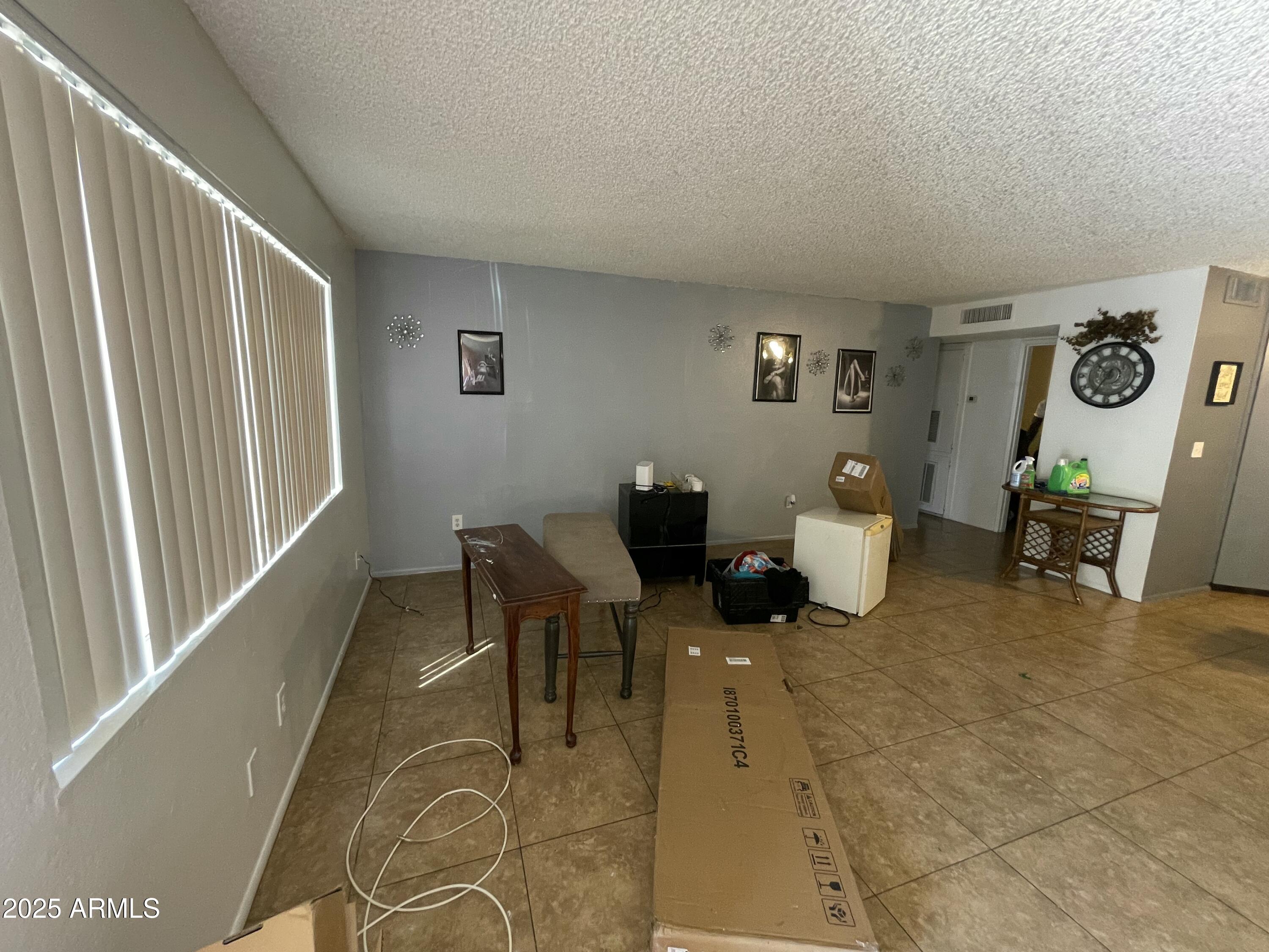 3364 West Harmont Drive Phoenix, AZ 85051 - Photo 18 of 39 a living room with furniture and a window