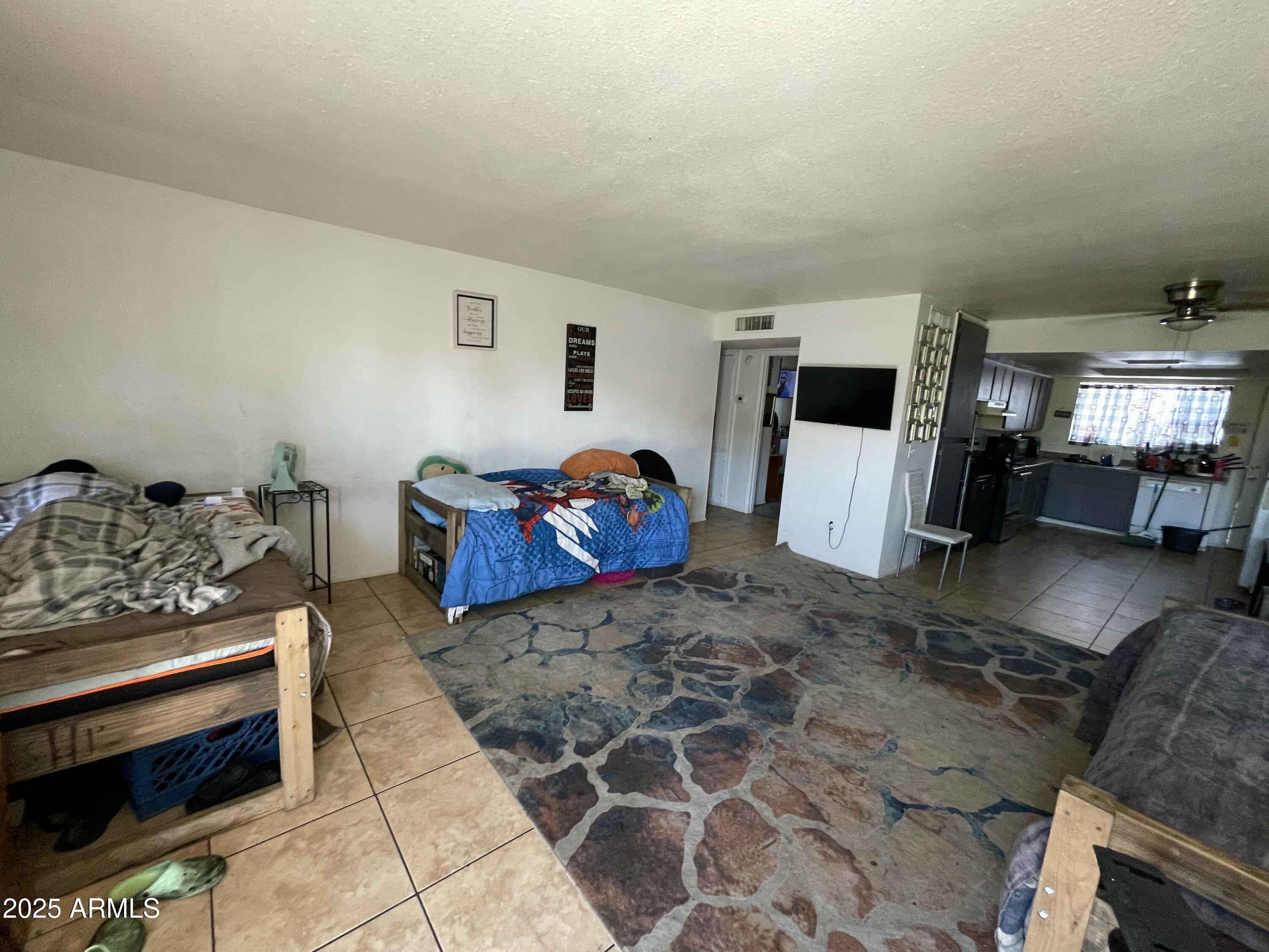 3364 West Harmont Drive Phoenix, AZ 85051 - Photo 26 of 39 a living room with furniture and a flat screen tv