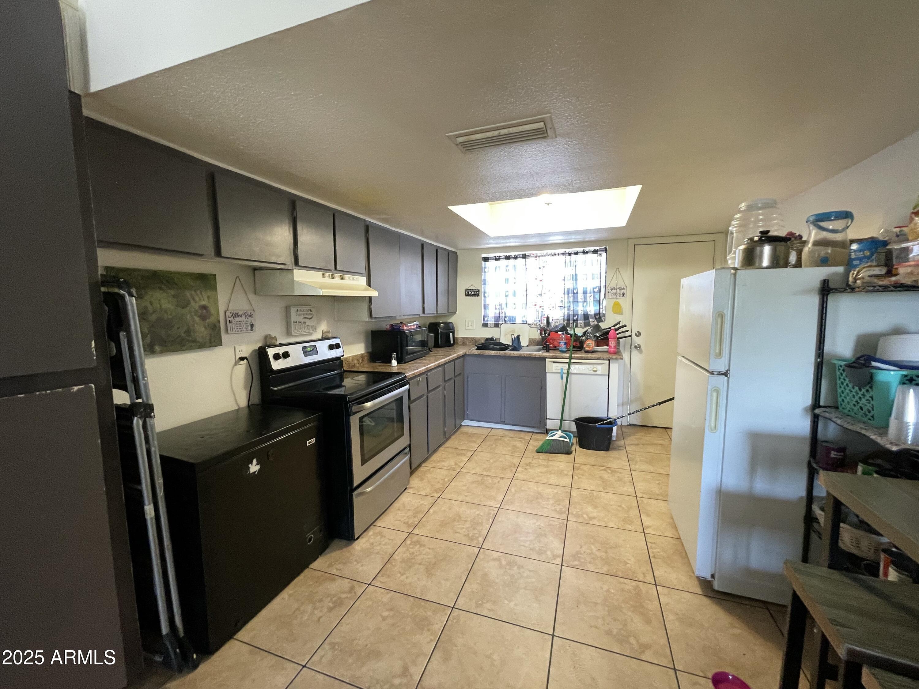 3364 West Harmont Drive Phoenix, AZ 85051 - Photo 27 of 39 a kitchen with stainless steel appliances granite countertop a refrigerator and a stove