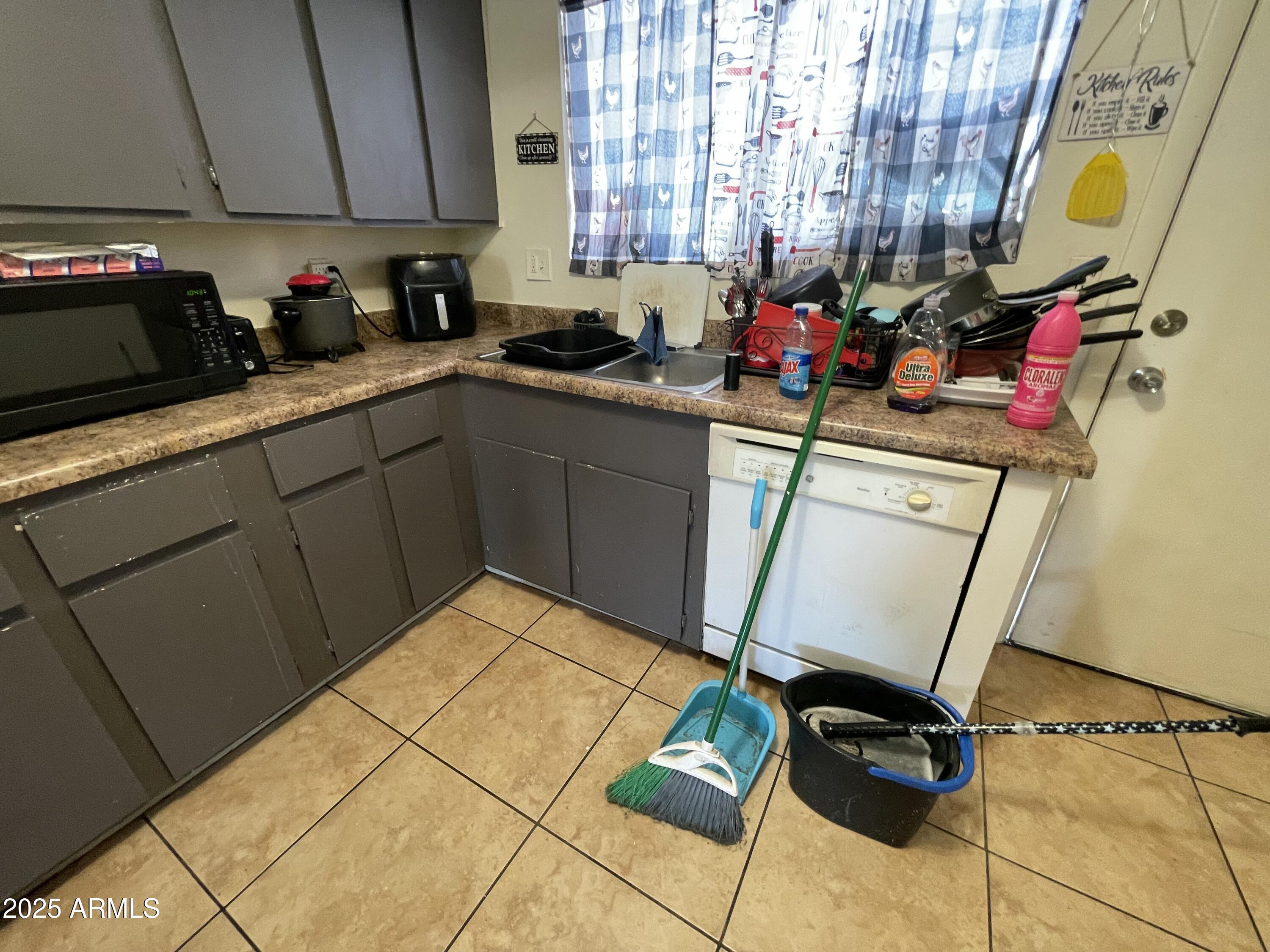3364 West Harmont Drive Phoenix, AZ 85051 - Photo 28 of 39 a kitchen with sink cabinets and appliances
