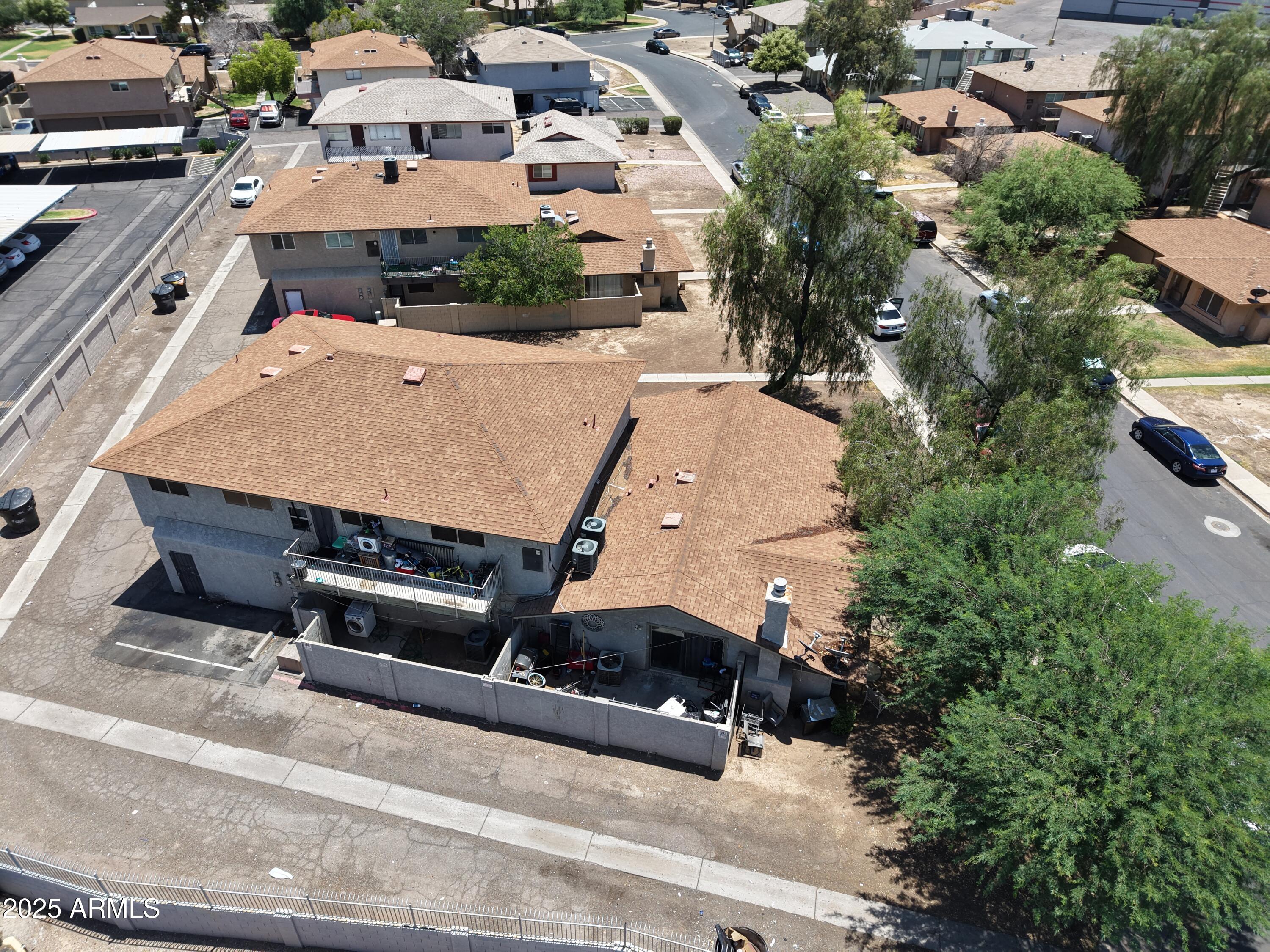 3364 West Harmont Drive Phoenix, AZ 85051 - Photo 3 of 39 an aerial view of a house with a yard