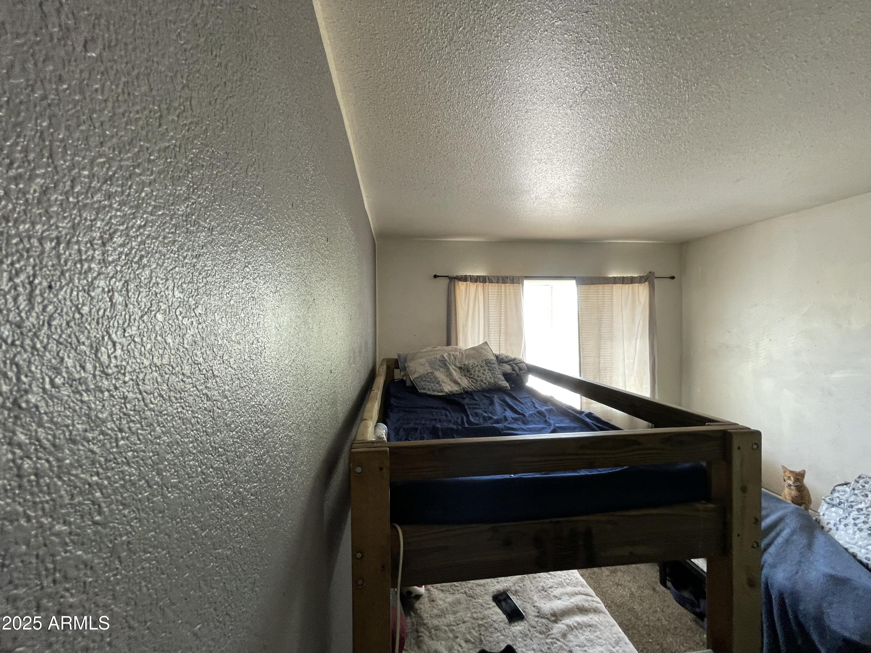 3364 West Harmont Drive Phoenix, AZ 85051 - Photo 32 of 39 a room with chair and window