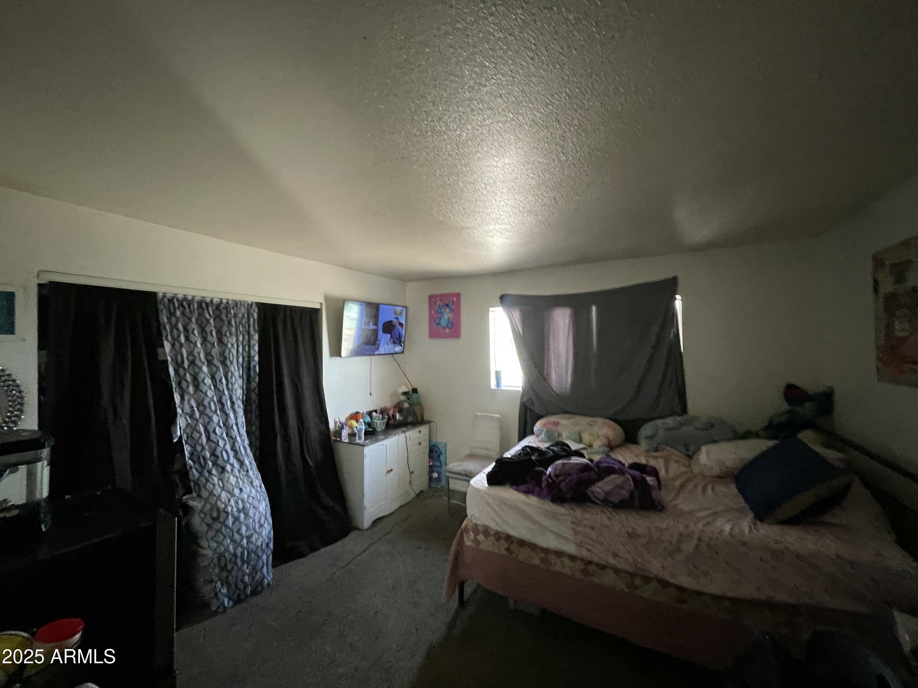 3364 West Harmont Drive Phoenix, AZ 85051 - Photo 33 of 39 a bed room with furniture and a window