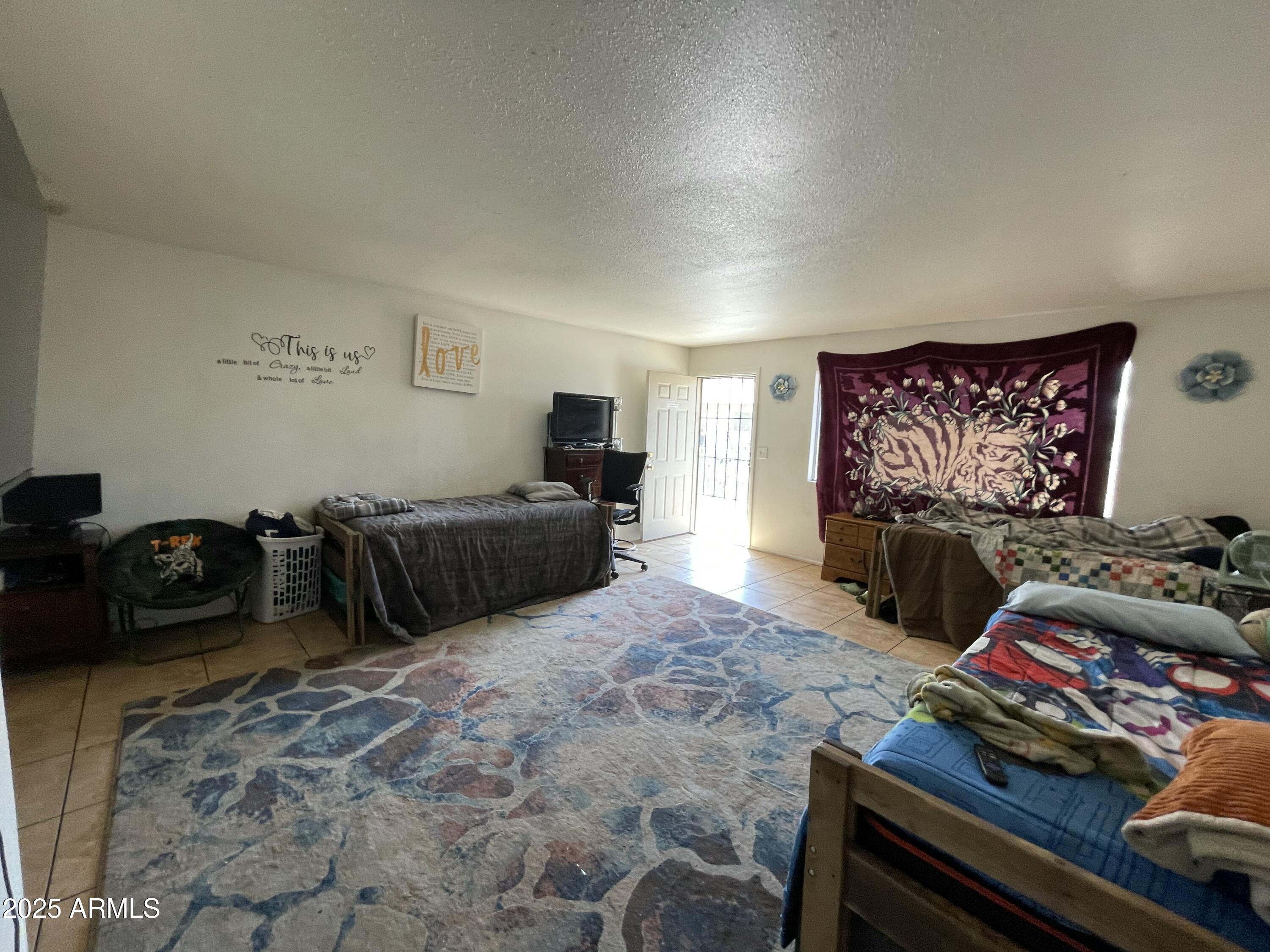 3364 West Harmont Drive Phoenix, AZ 85051 - Photo 34 of 39 a living room with furniture and a flat screen tv