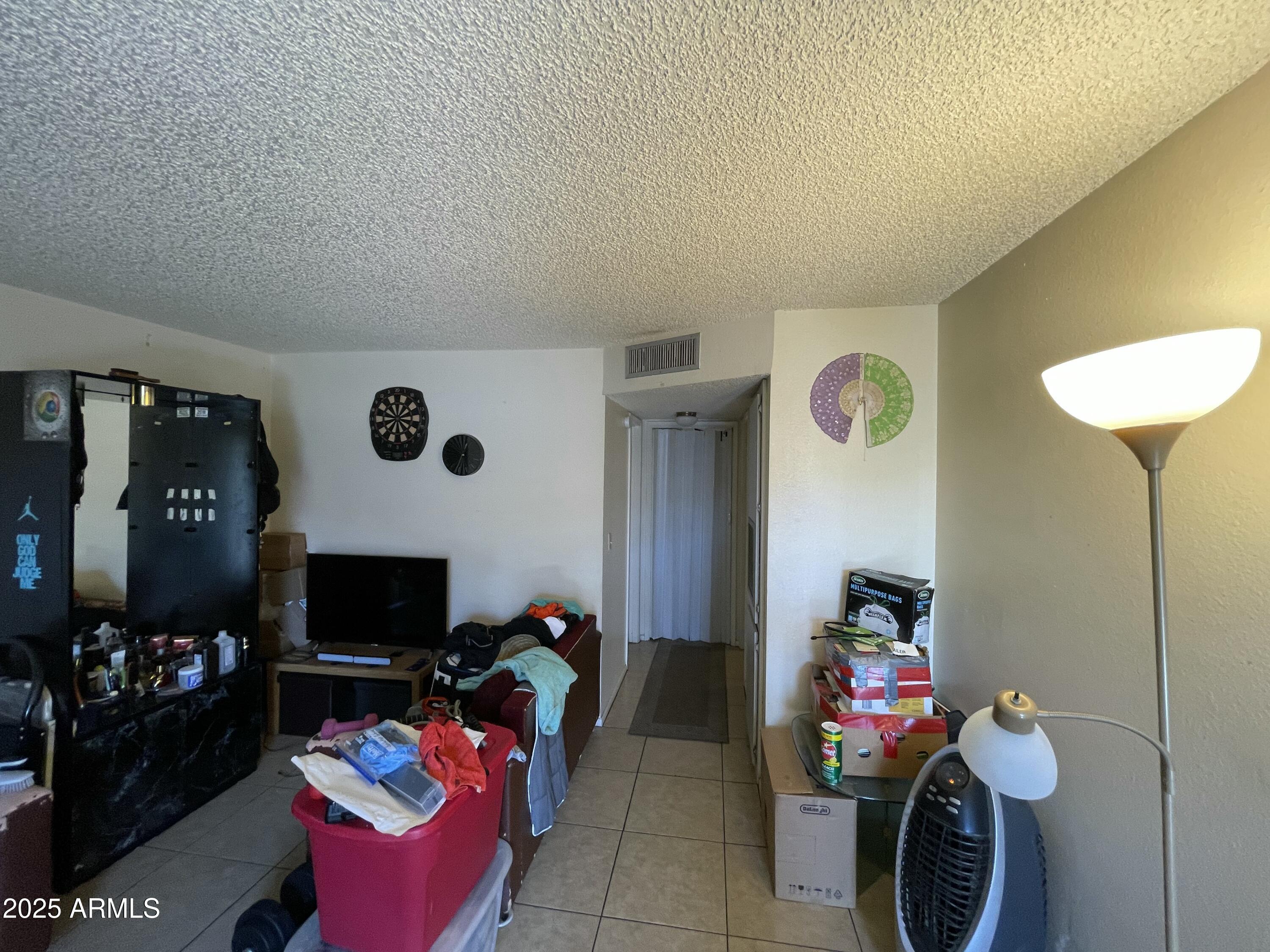 3364 West Harmont Drive Phoenix, AZ 85051 - Photo 35 of 39 a living room with furniture a flat screen tv and a fireplace