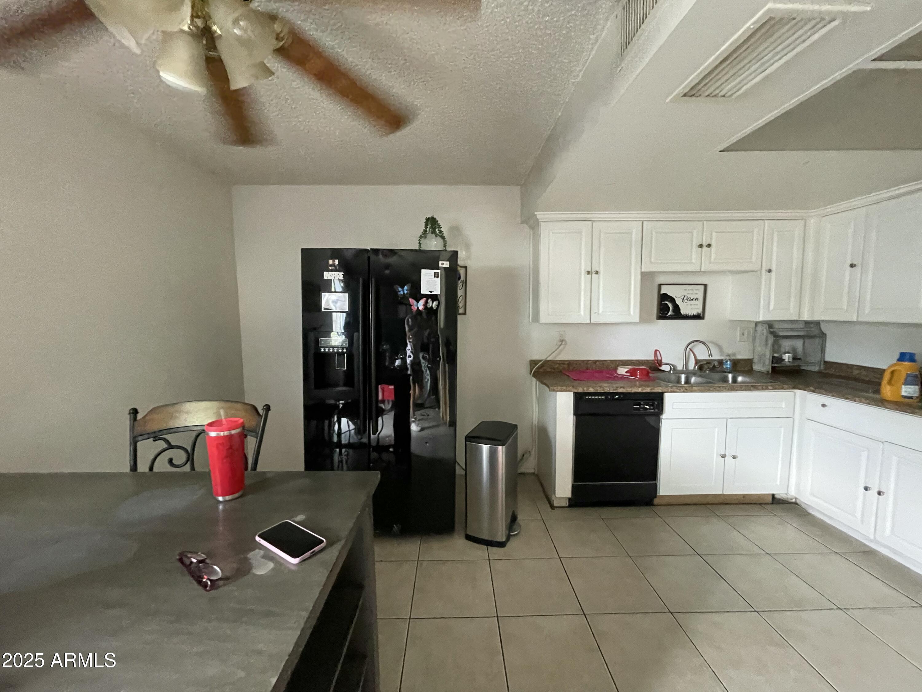 3364 West Harmont Drive Phoenix, AZ 85051 - Photo 9 of 39 a kitchen that has a lot of cabinets