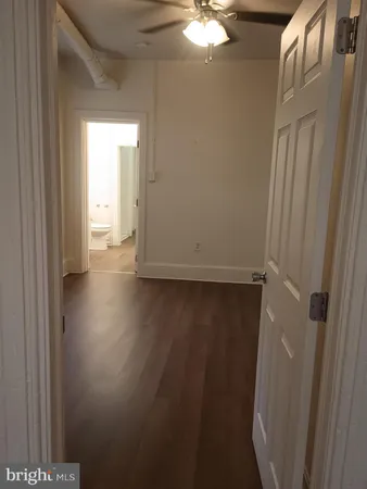 a view of a livingroom with wooden floor and window