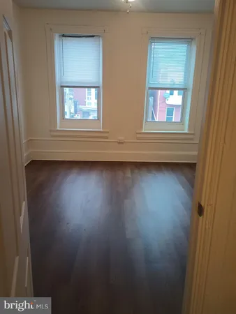 a view of a room with wooden floor
