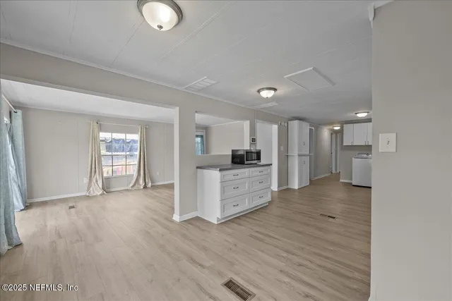 a view of kitchen with refrigerator sink and wooden floor