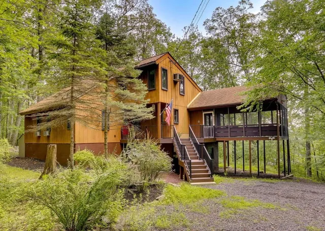 a front view of a house with a yard table and chairs