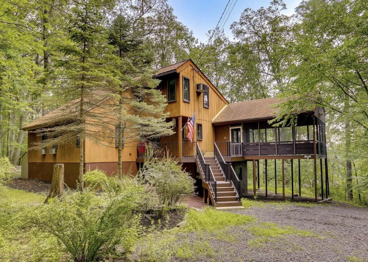 a front view of a house with a yard table and chairs
