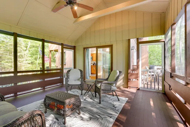 a living room with furniture and floor to ceiling windows