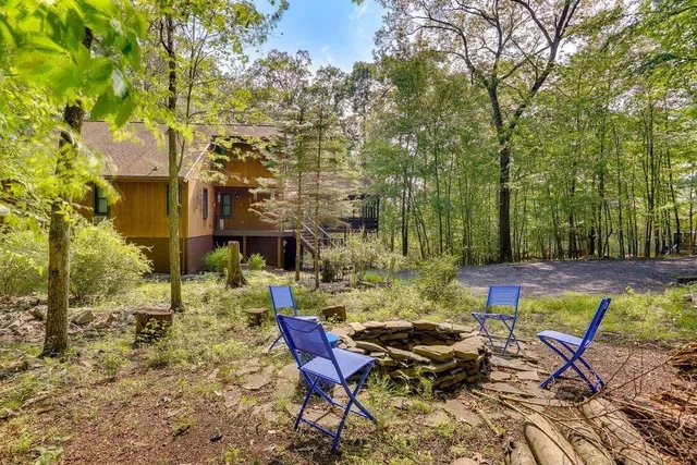 a view of a chairs and table in backyard