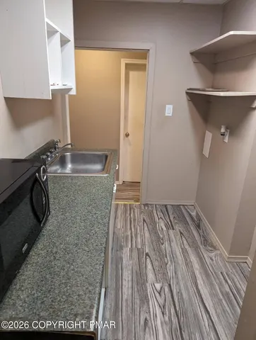 a bathroom with a sink toilet and a mirror