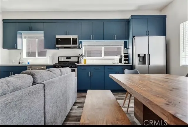 a kitchen with stainless steel appliances kitchen island granite countertop a refrigerator stove microwave and sink