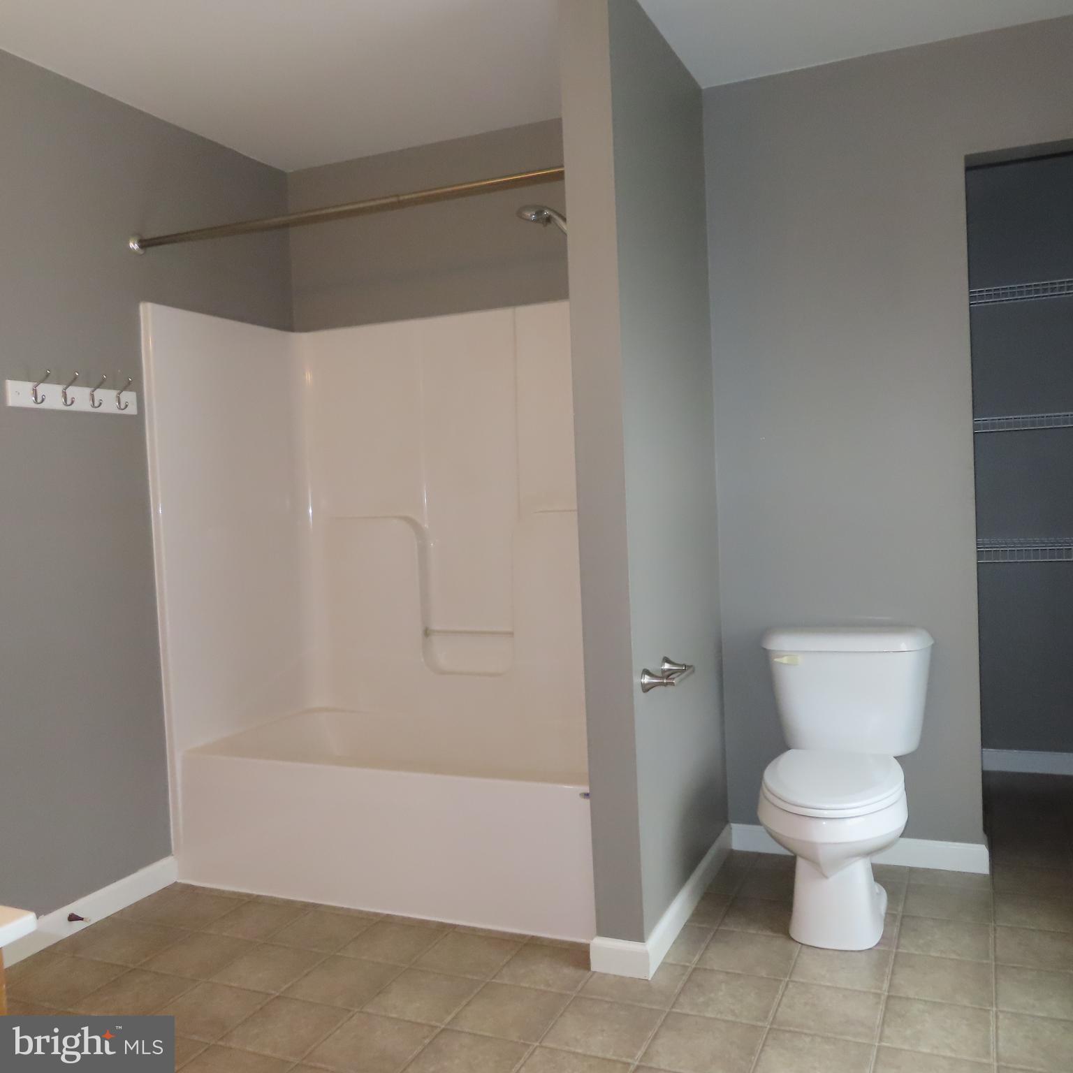 5237 Rolling Road, Unit H Chambersburg, PA 17202 - Photo 20 of 36 a white toilet sitting next to a bathroom sink