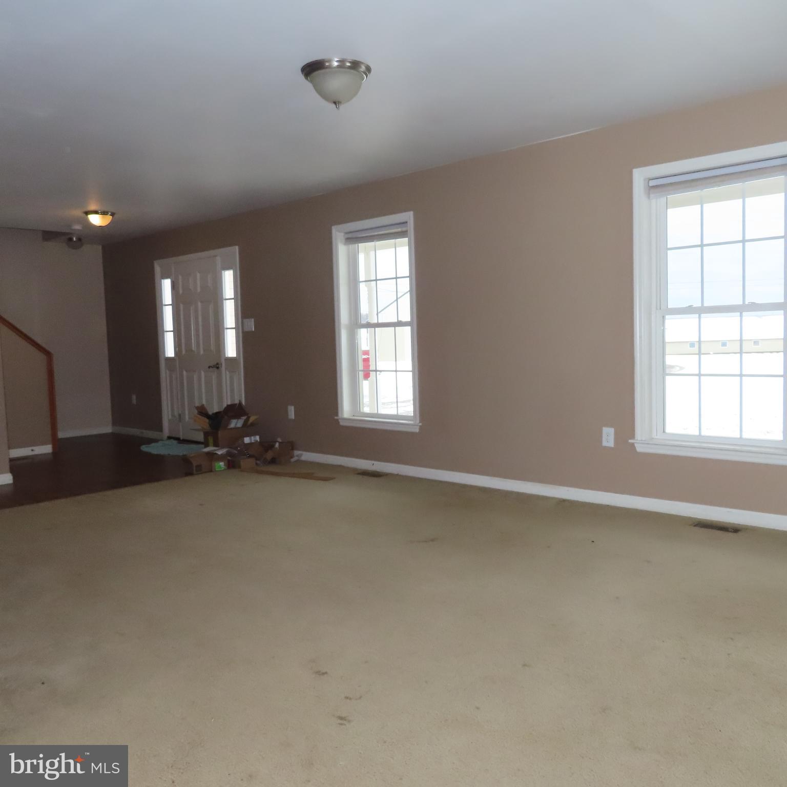5237 Rolling Road, Unit H Chambersburg, PA 17202 - Photo 3 of 36 an empty room with windows and view of kitchen