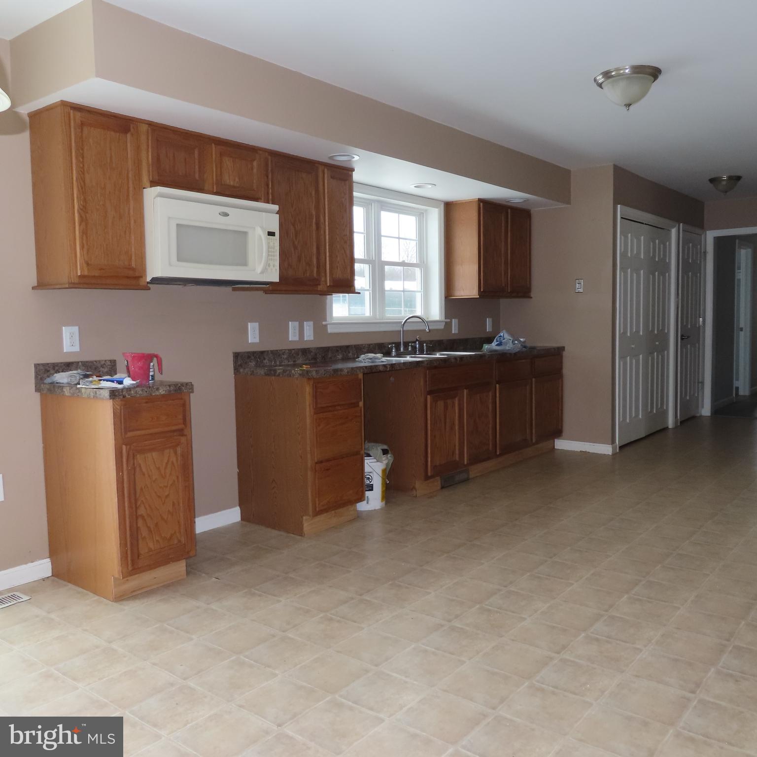 5237 Rolling Road, Unit H Chambersburg, PA 17202 - Photo 5 of 36 a kitchen with granite countertop a sink stove and cabinets