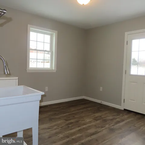 a room with a sink and a mirror