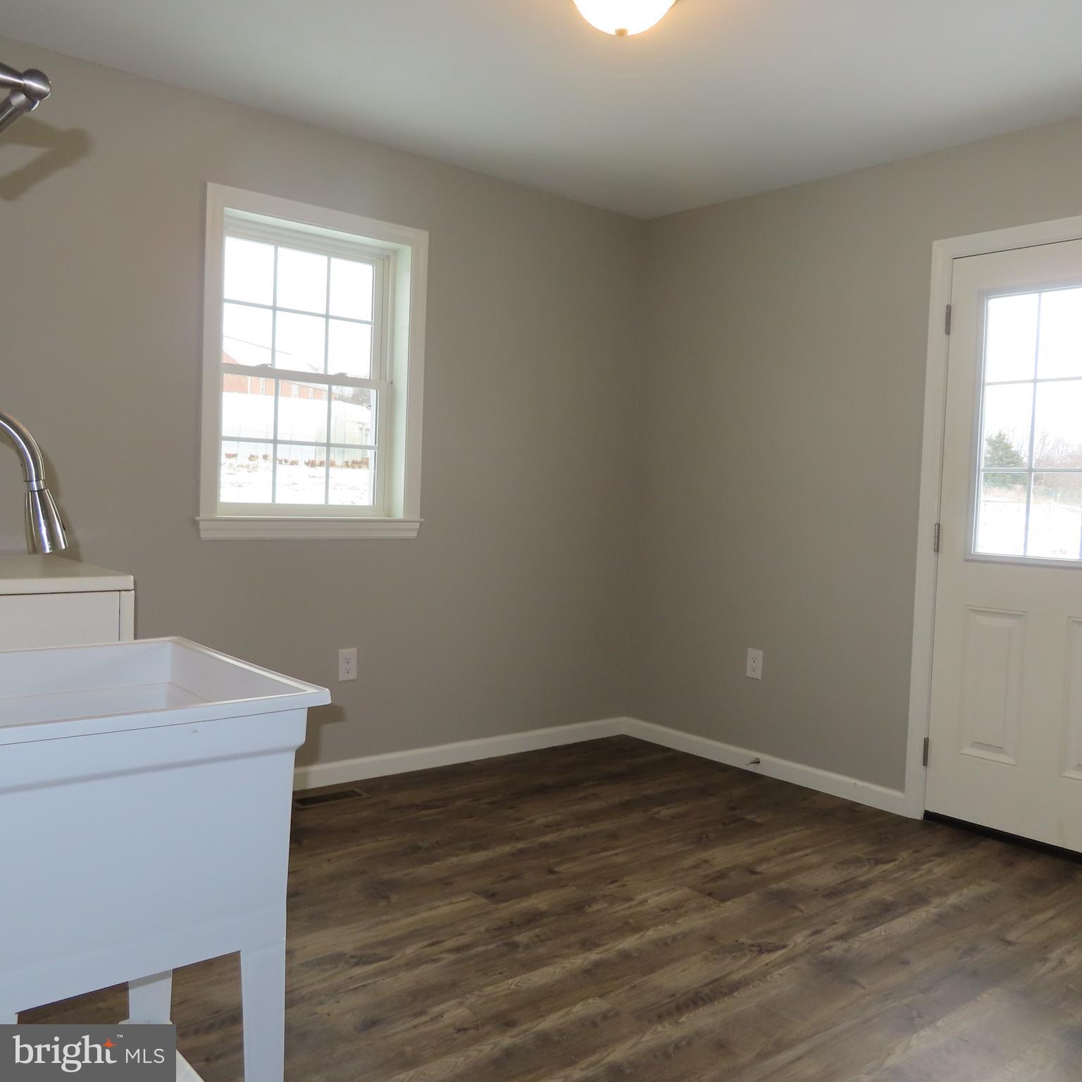 5237 Rolling Road, Unit H Chambersburg, PA 17202 - Photo 10 of 36 an empty room with wooden floor and windows