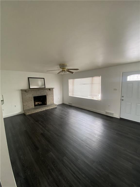 156 Terrace Drive Monongahela, PA 15063 - Photo 9 of 24 an empty room with wooden floor fireplace and windows