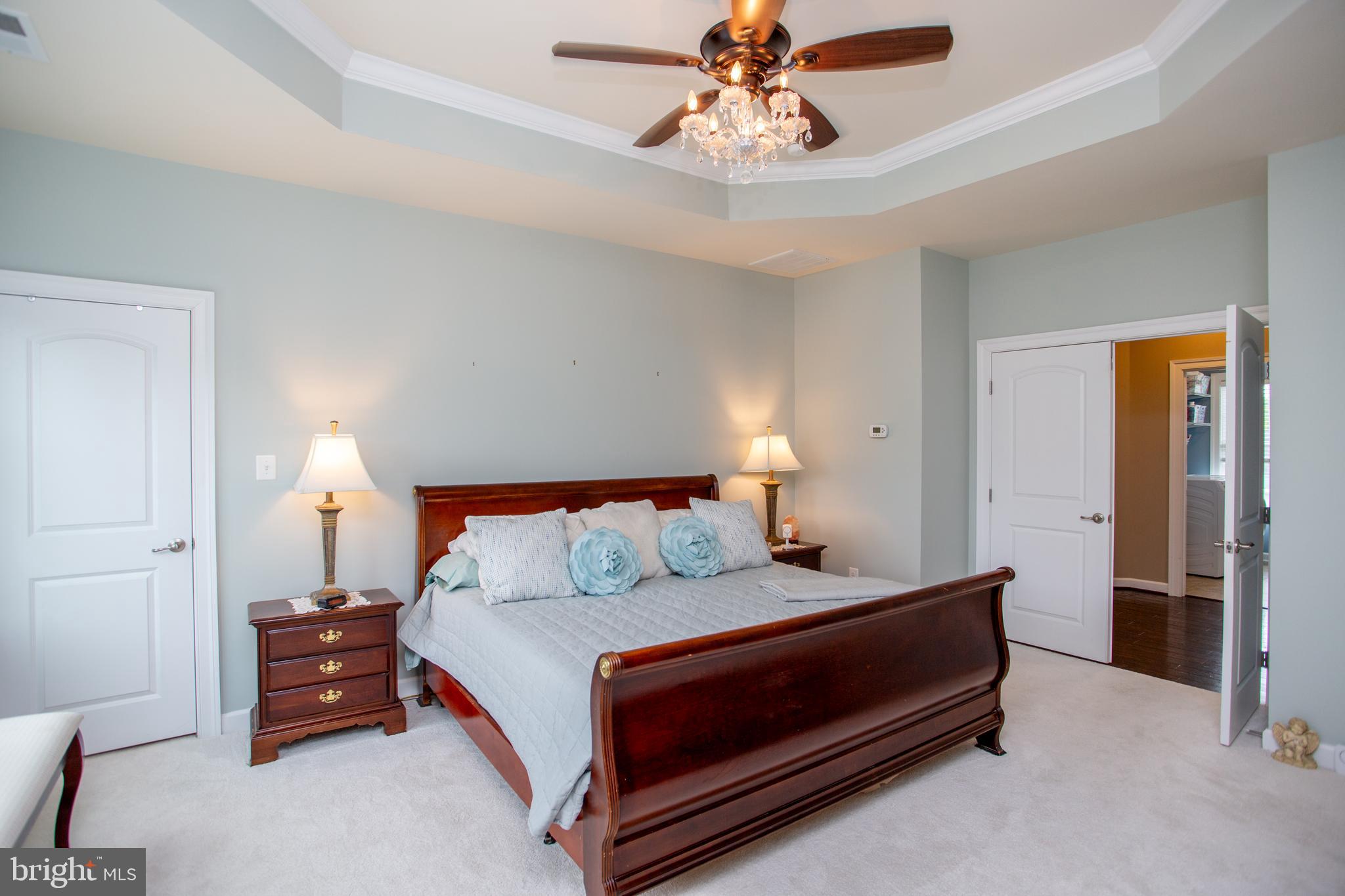 4682 Plough Tavern Road Doylestown, PA 18902 - Photo 19 of 42 a bedroom with a bed and a chandelier