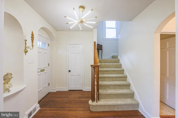 a view of an entryway with wooden floor and windows