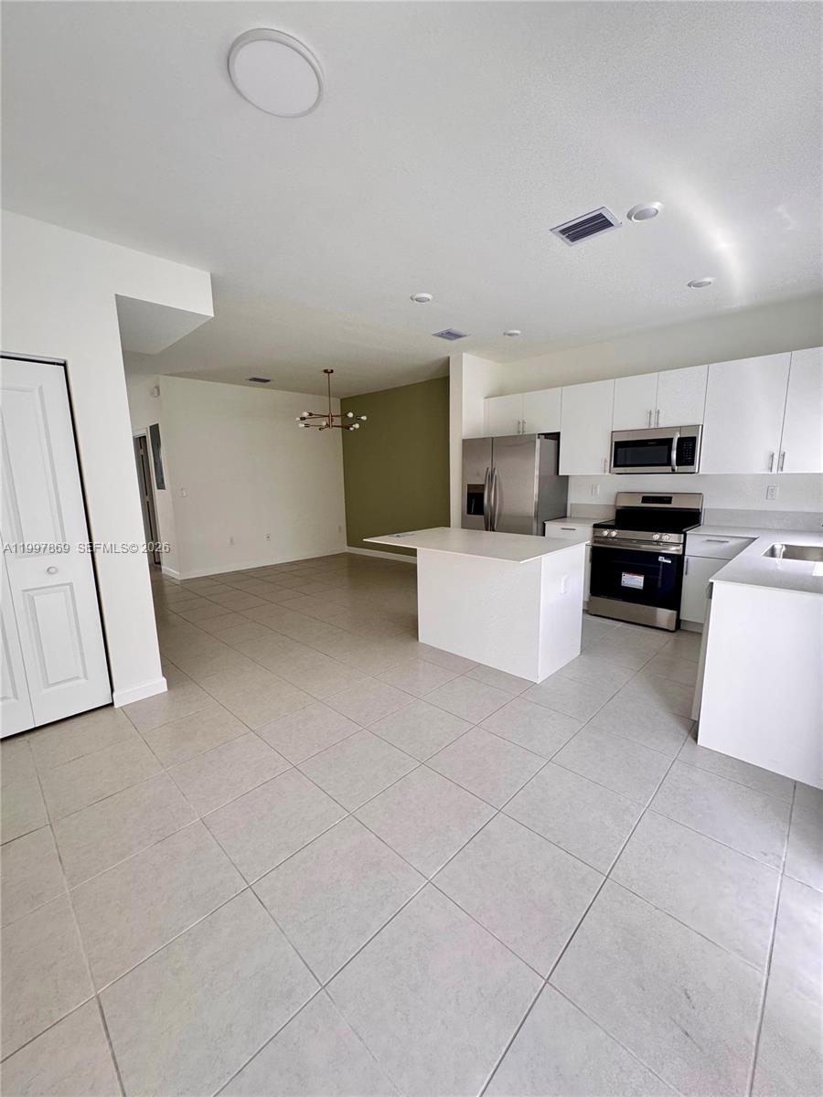 15538 Southwest 276th Terrace Homestead, FL 33032 - Photo 11 of 16 a living room with furniture and a flat screen tv