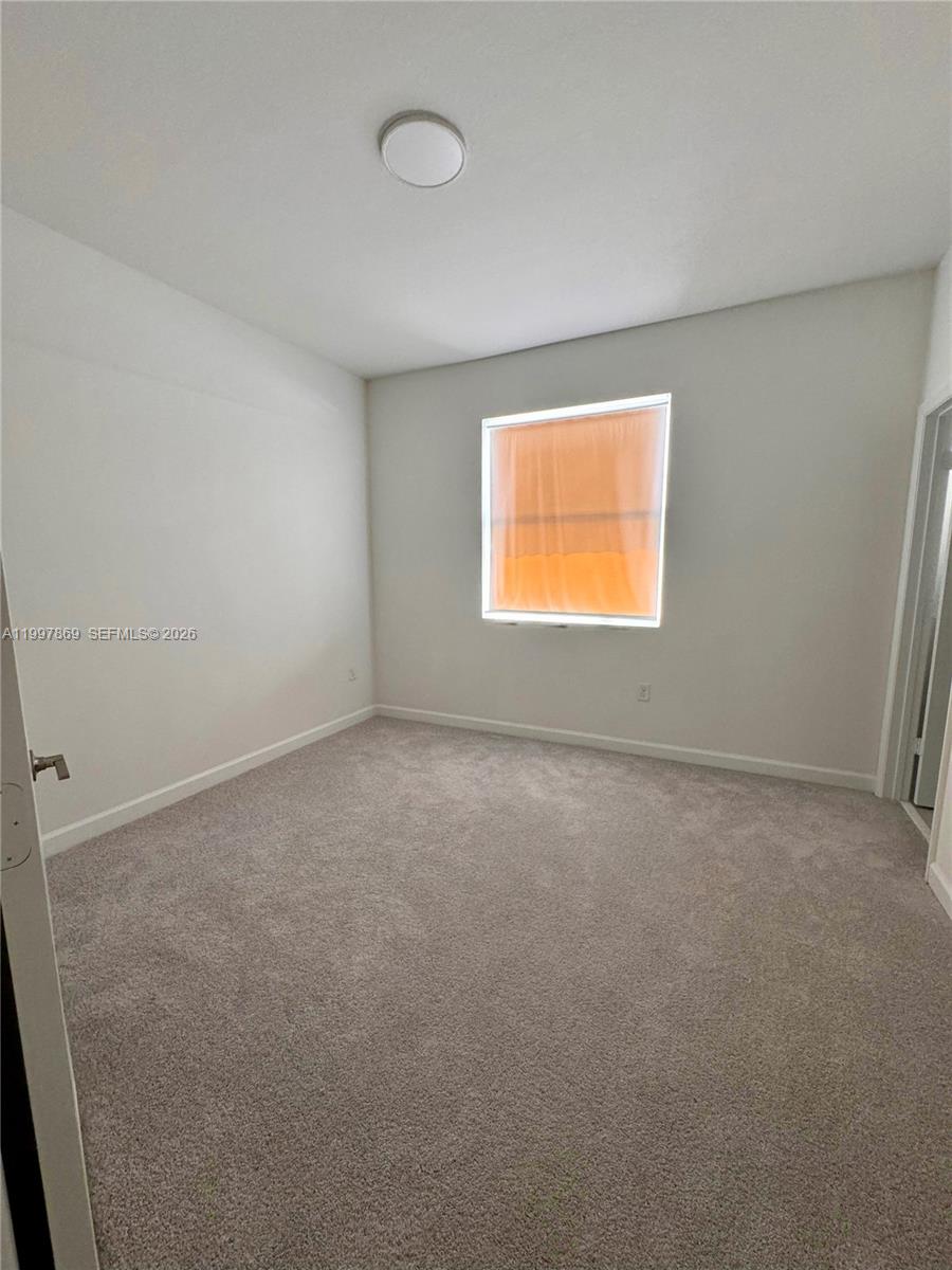 15538 Southwest 276th Terrace Homestead, FL 33032 - Photo 12 of 16 an empty room with a window