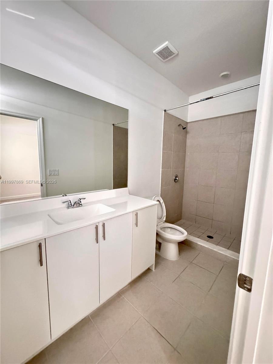 15538 Southwest 276th Terrace Homestead, FL 33032 - Photo 13 of 16 a bathroom with a sink a toilet and shower