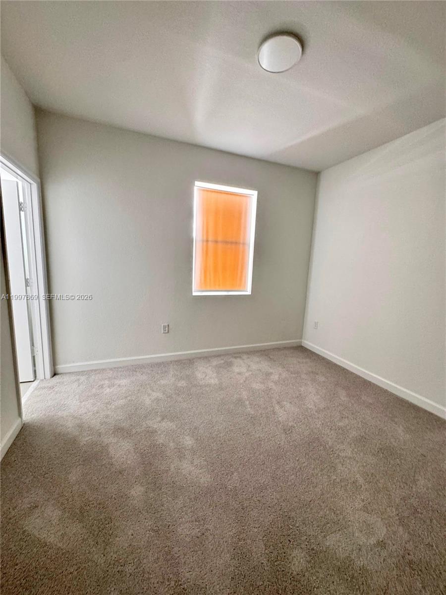 15538 Southwest 276th Terrace Homestead, FL 33032 - Photo 15 of 16 an empty room with a window