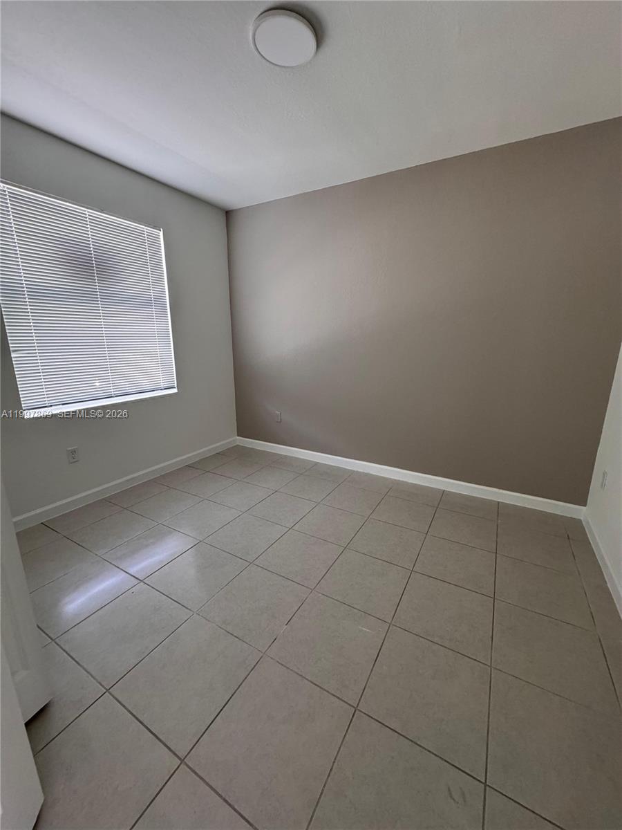 15538 Southwest 276th Terrace Homestead, FL 33032 - Photo 3 of 16 an empty room with windows
