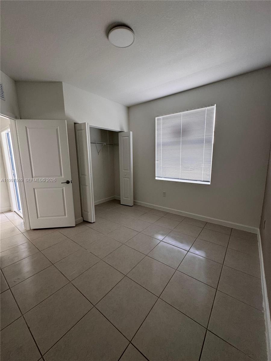 15538 Southwest 276th Terrace Homestead, FL 33032 - Photo 4 of 16 a view of an empty room with a window