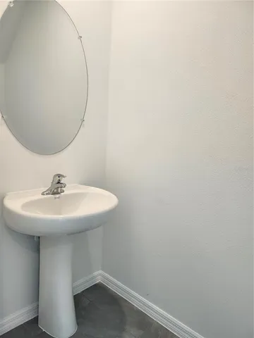a bathroom with a sink and mirror