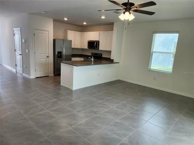 a kitchen with stainless steel appliances a refrigerator sink and microwave
