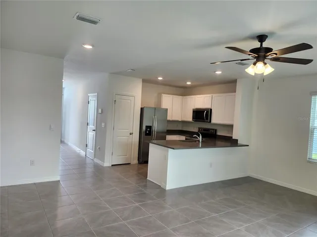 a kitchen with stainless steel appliances a refrigerator and a microwave