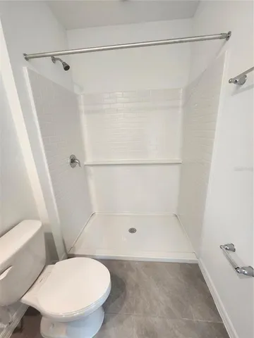 a bathroom with a shower and a toilet