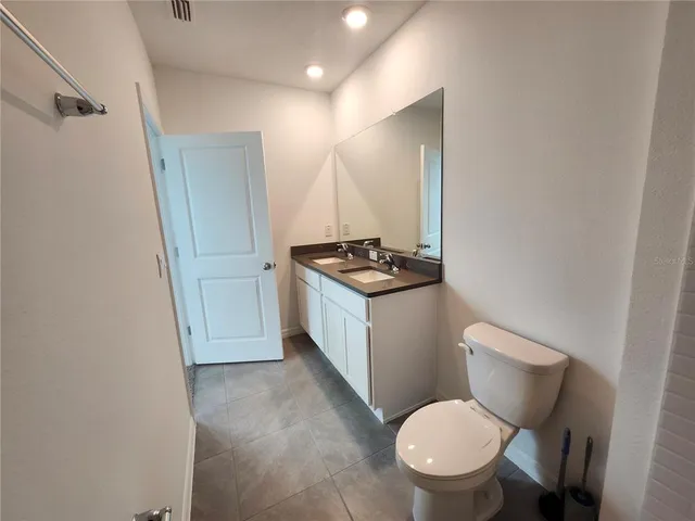 a bathroom with a toilet a sink and a mirror