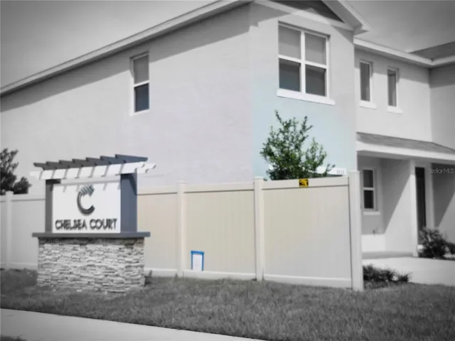 a view of a street with a building and palm trees