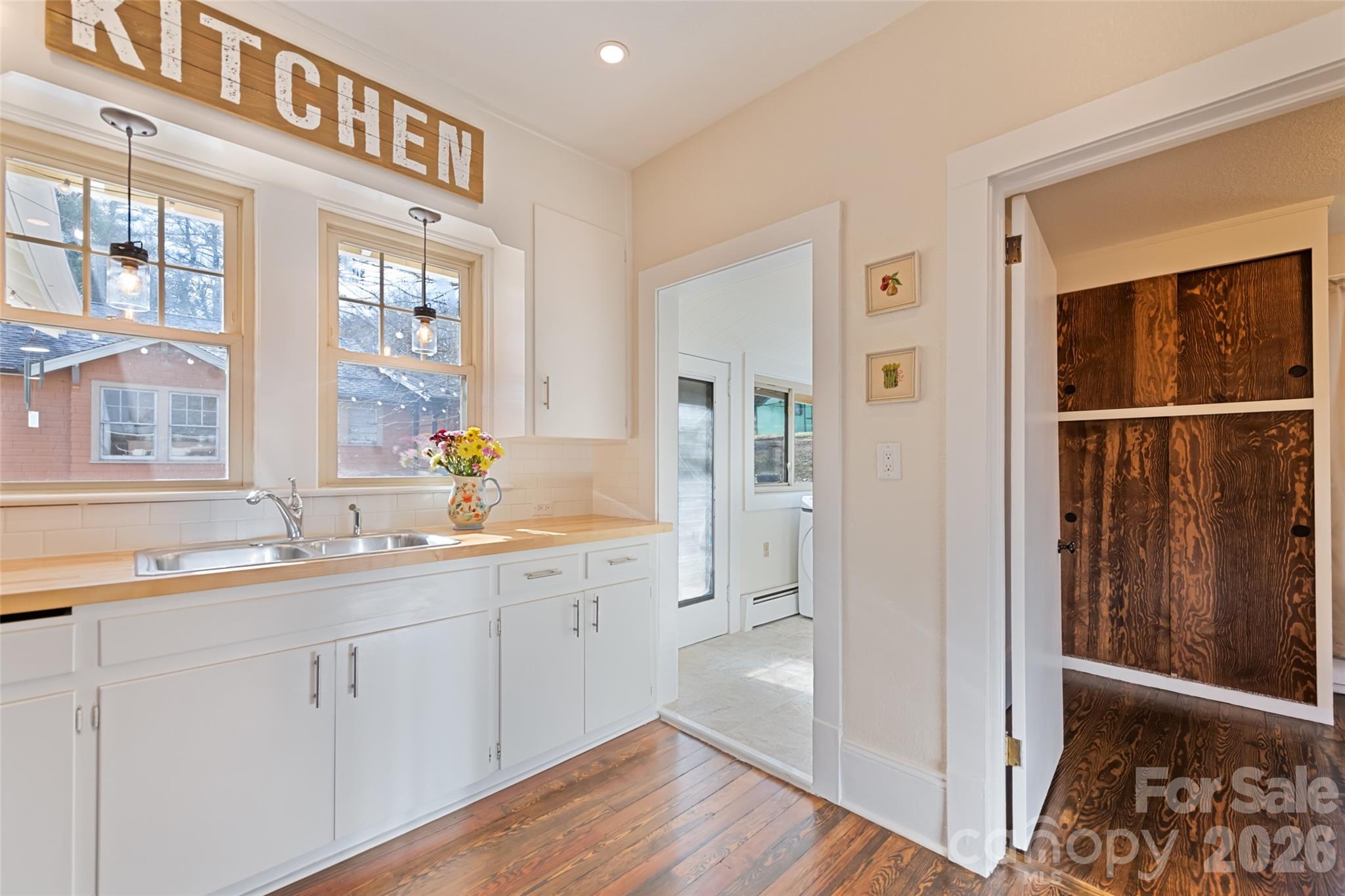 57 Fiddle Drive Canton, NC 28716 - Photo 18 of 35 a view of a kitchen with a sink and dishwasher with wooden floor