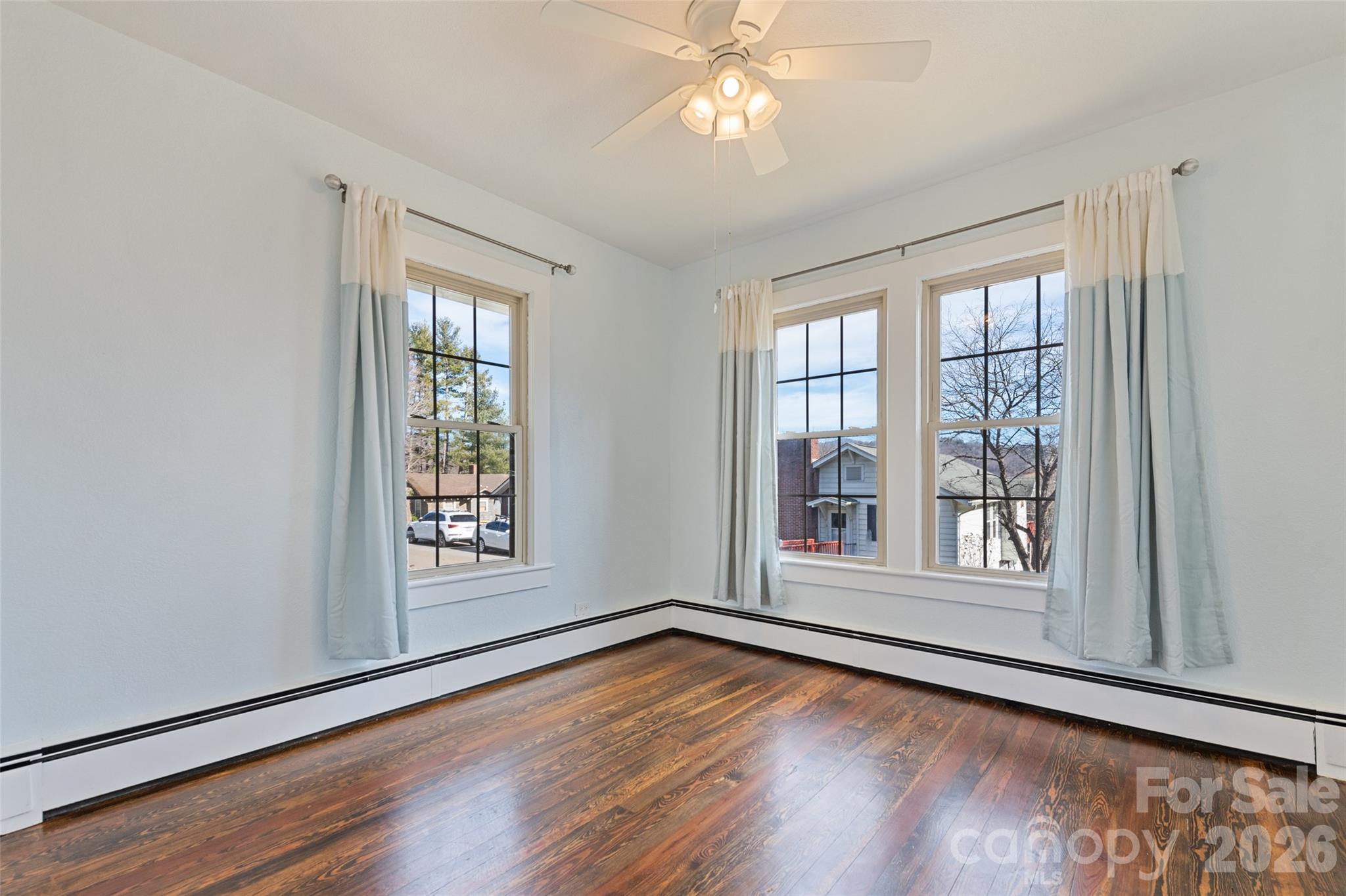 57 Fiddle Drive Canton, NC 28716 - Photo 21 of 35 an empty room with wooden floor and windows